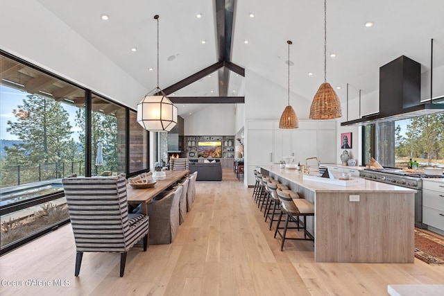 kitchen featuring modern cabinets, island range hood, and decorative light fixtures