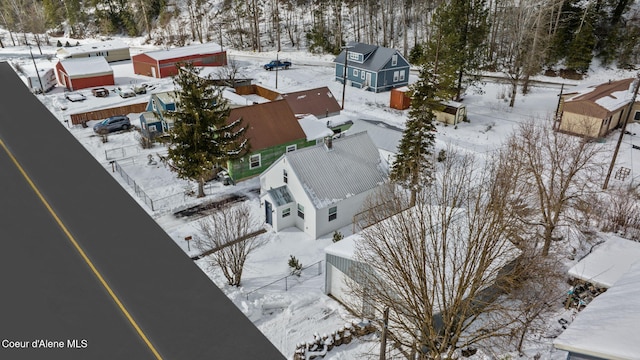 snowy aerial view featuring a residential view