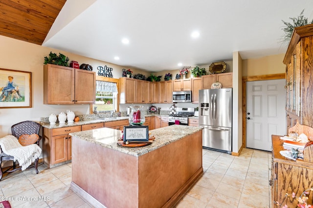 kitchen featuring light tile patterned floors, light stone countertops, recessed lighting, appliances with stainless steel finishes, and a center island