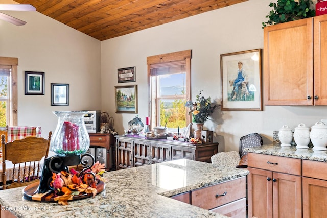 kitchen featuring vaulted ceiling, wooden ceiling, and light stone countertops