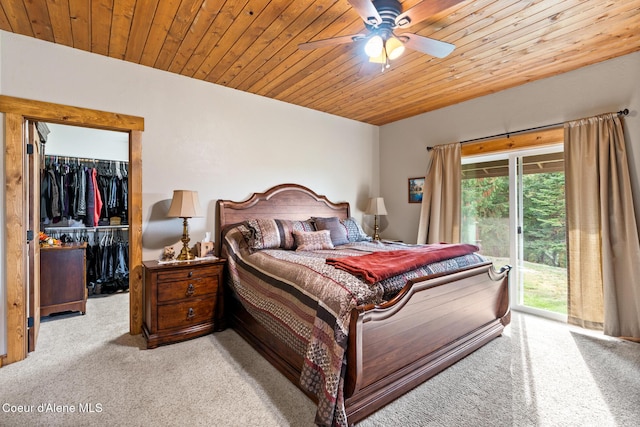 bedroom with access to outside, wood ceiling, light colored carpet, and a spacious closet