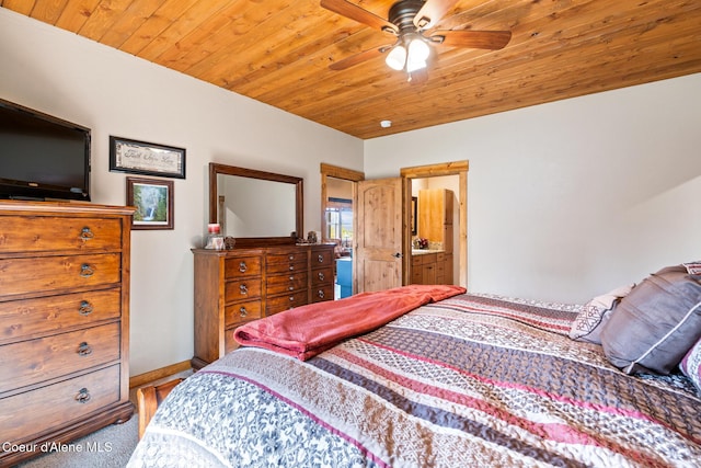 bedroom featuring carpet floors, wooden ceiling, ensuite bath, and baseboards