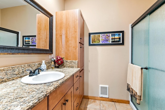 bathroom with a stall shower, vanity, visible vents, and tile patterned floors