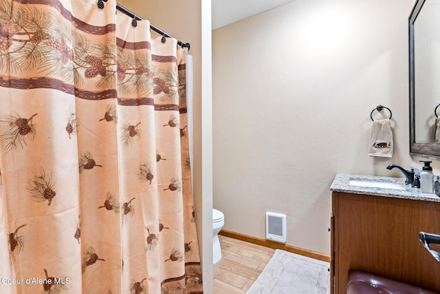 full bathroom featuring visible vents, toilet, vanity, wood finished floors, and baseboards