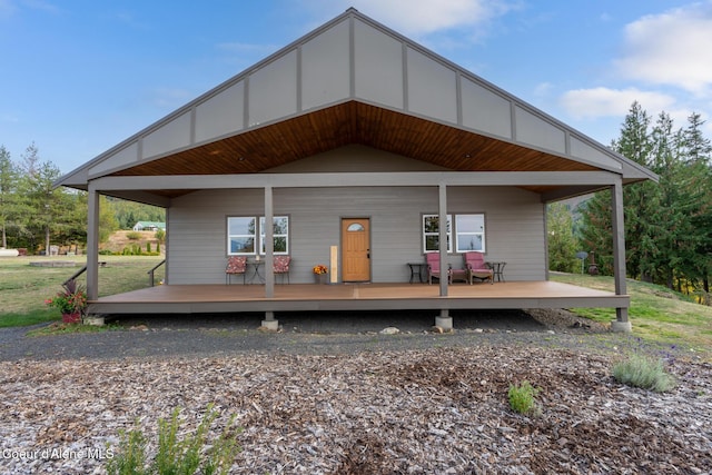 back of property featuring covered porch