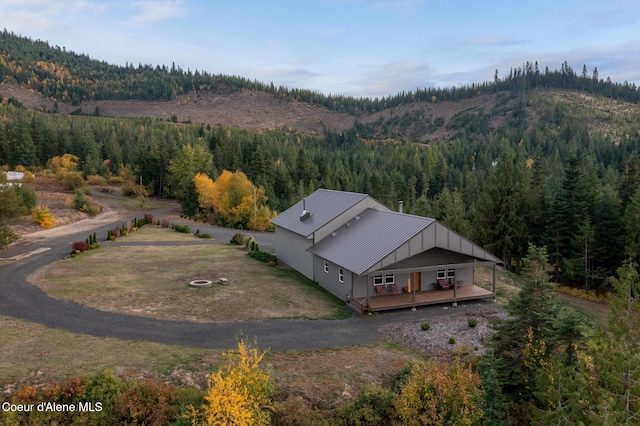 birds eye view of property with a mountain view and a forest view