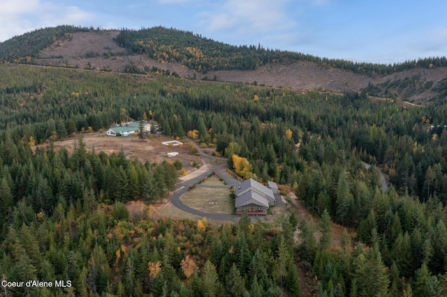 birds eye view of property with a mountain view and a view of trees