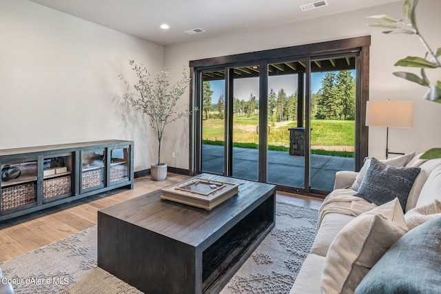 living area with recessed lighting, baseboards, and wood finished floors