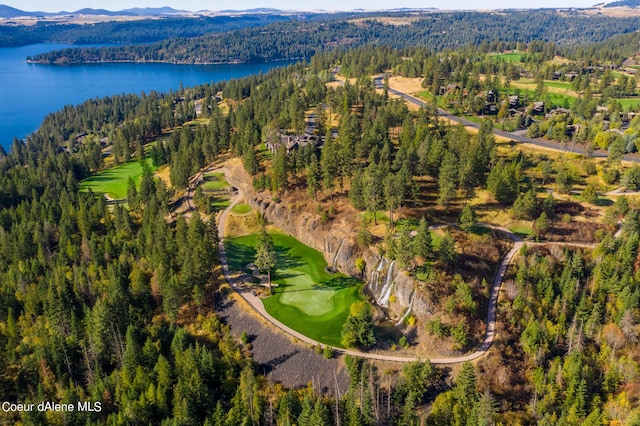 birds eye view of property with a water view, view of golf course, and a wooded view