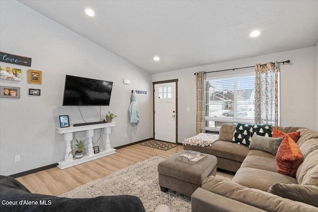 living room featuring light wood-type flooring, baseboards, vaulted ceiling, and recessed lighting