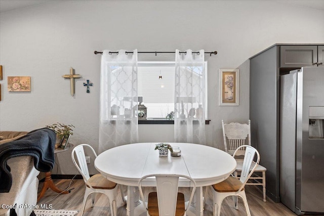 dining space with wood finished floors