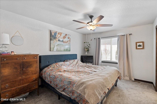 bedroom with a textured ceiling, a ceiling fan, light colored carpet, and baseboards