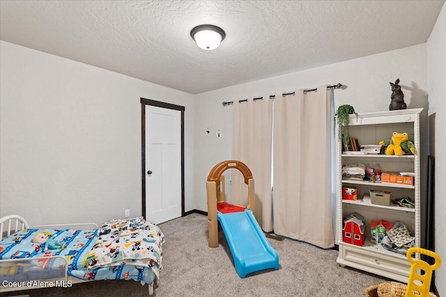 bedroom with light carpet and a textured ceiling