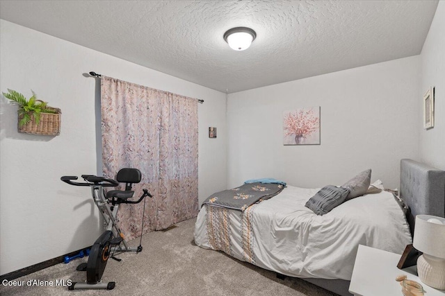 bedroom with a textured ceiling and carpet flooring