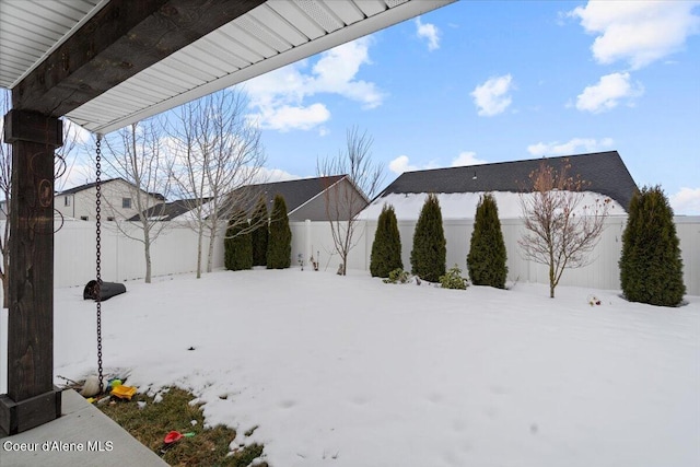 yard covered in snow featuring a fenced backyard