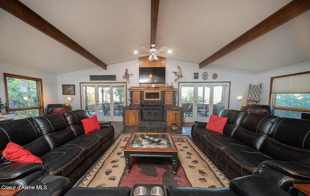 living room featuring lofted ceiling with beams, a wealth of natural light, and french doors