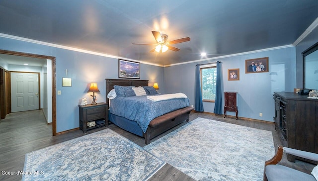 bedroom with ceiling fan, baseboards, crown molding, and wood finished floors