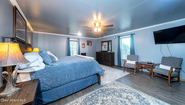 bedroom with ceiling fan, ornamental molding, and wood finished floors