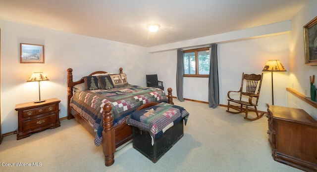 bedroom featuring baseboards and light colored carpet