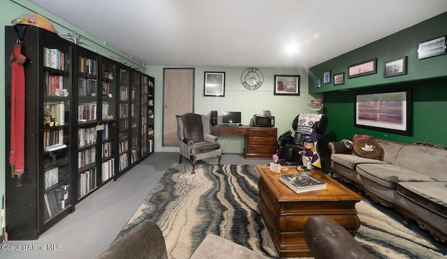 home office with concrete block wall and finished concrete flooring