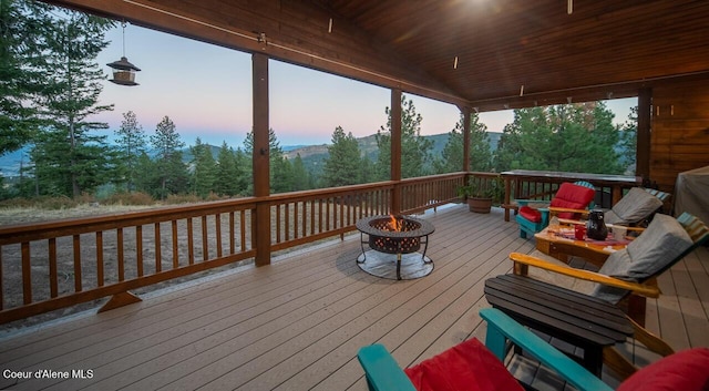 deck at dusk with a fire pit