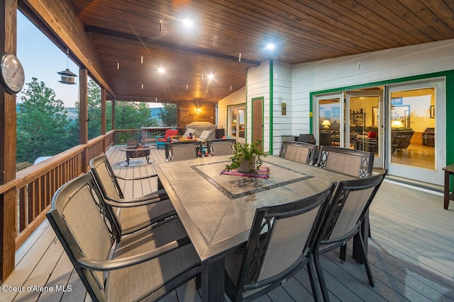 wooden terrace featuring outdoor dining space