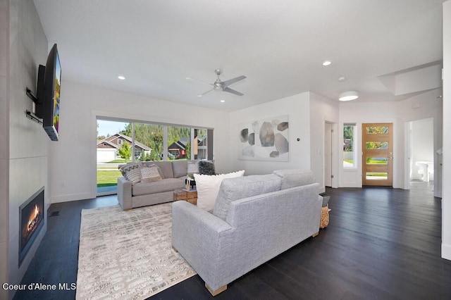 living room with ceiling fan, recessed lighting, a fireplace, baseboards, and dark wood-style floors