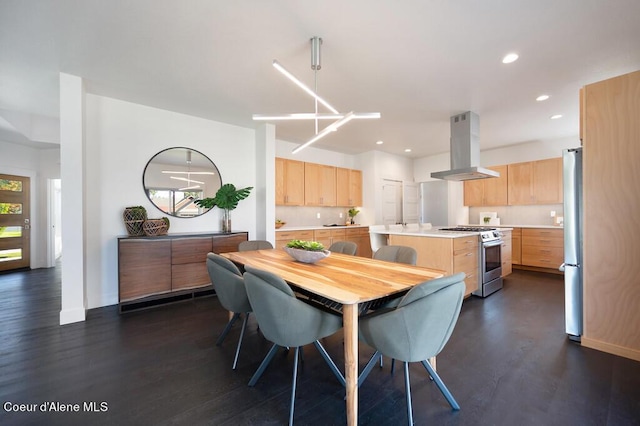 dining room featuring baseboards, dark wood-type flooring, and recessed lighting