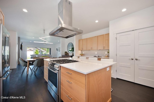 kitchen with island exhaust hood, stainless steel appliances, light countertops, light brown cabinets, and a kitchen island