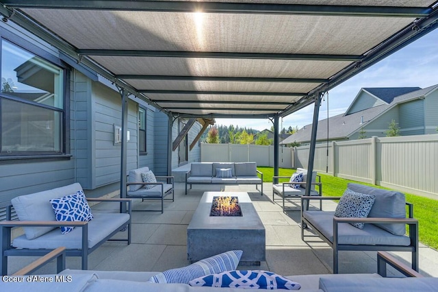 view of patio / terrace with a fenced backyard and an outdoor living space with a fire pit