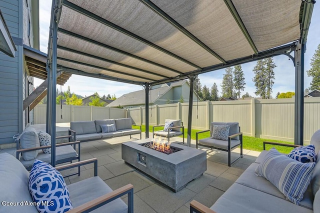 view of patio / terrace featuring a fenced backyard and an outdoor living space with a fire pit