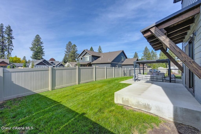 view of yard featuring a patio area, a fenced backyard, and a residential view