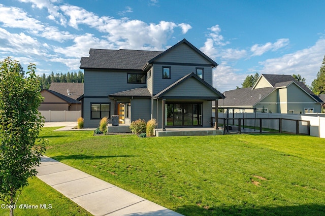 back of property featuring fence private yard and a lawn