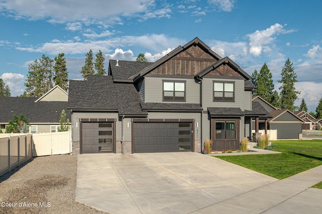 view of front of house featuring an attached garage, a shingled roof, fence, driveway, and a front lawn