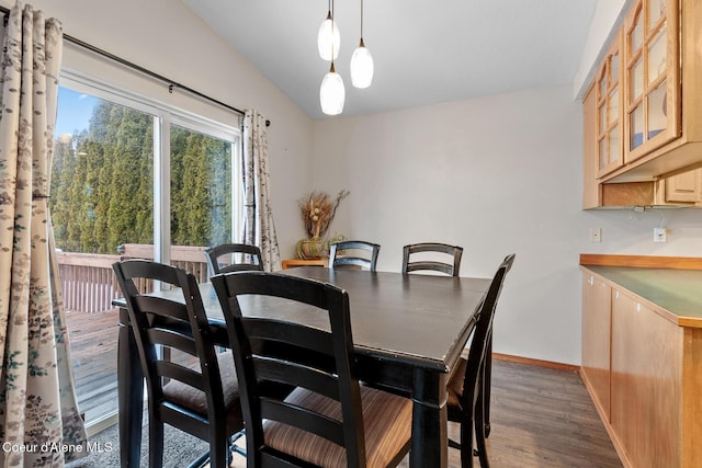 dining space featuring dark wood-style floors and baseboards