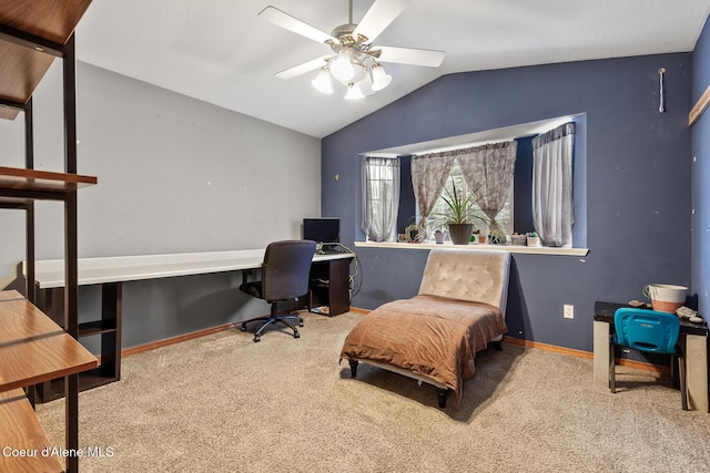 carpeted home office featuring vaulted ceiling, ceiling fan, and baseboards