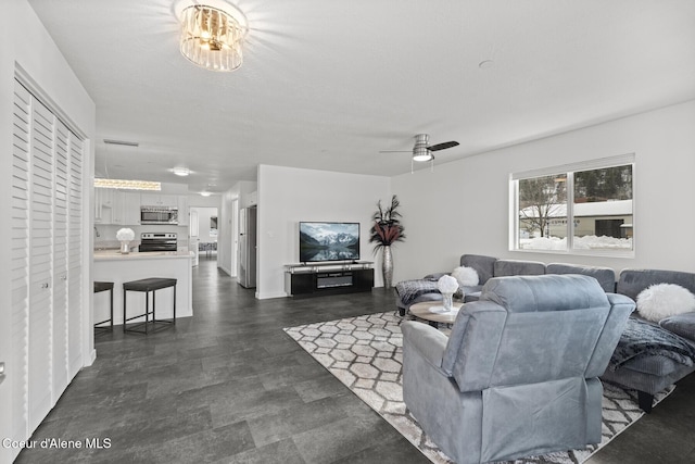 living area featuring ceiling fan and visible vents