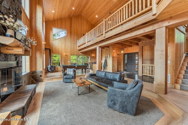 living room featuring wood ceiling, stairway, pool table, wood walls, and high vaulted ceiling