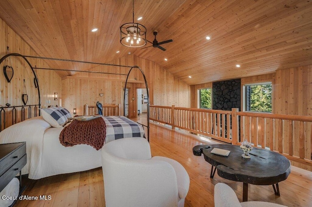 bedroom with vaulted ceiling, hardwood / wood-style floors, wood walls, and wooden ceiling