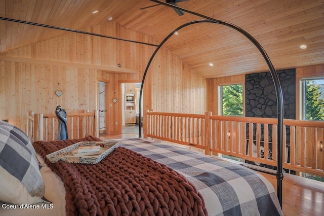 bedroom featuring wood ceiling, multiple windows, wood walls, and wood finished floors