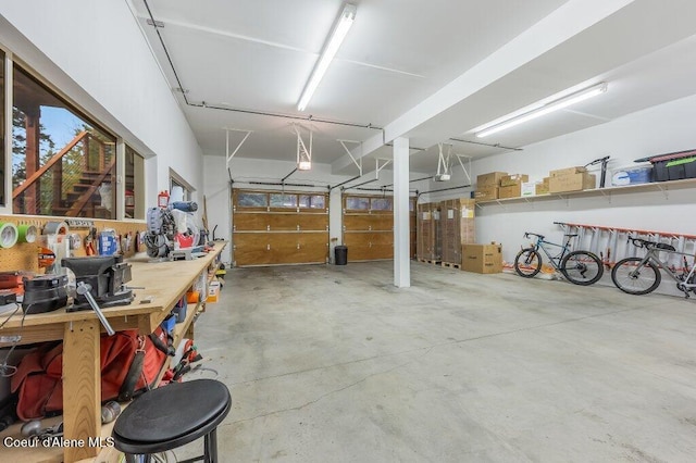 garage with a workshop area and a garage door opener