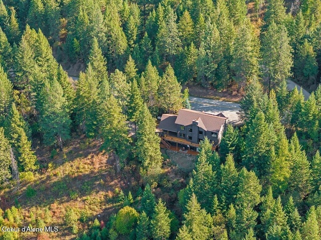 bird's eye view with a wooded view