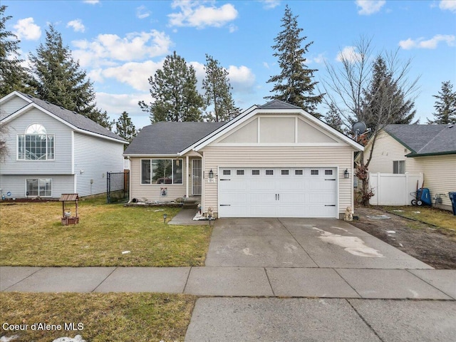 view of front of home with driveway, an attached garage, fence, and a front lawn