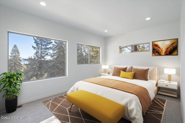 bedroom with baseboards, multiple windows, dark carpet, and recessed lighting