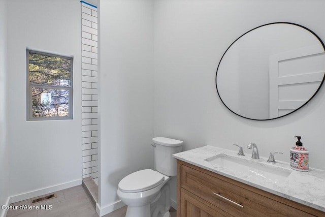 full bathroom featuring a stall shower, baseboards, visible vents, toilet, and vanity