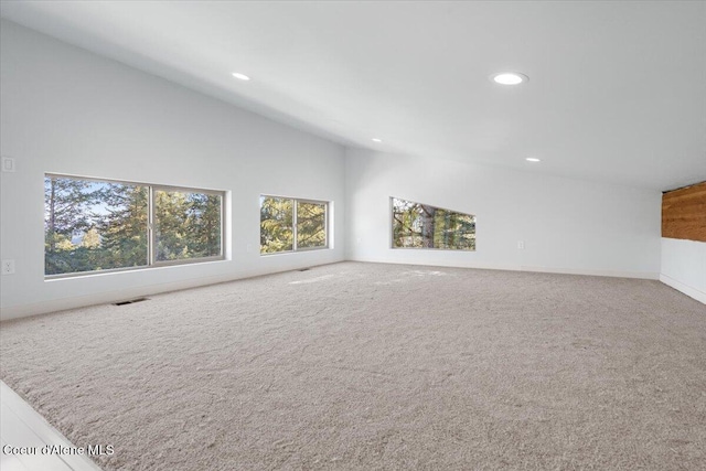 unfurnished living room with carpet floors, recessed lighting, visible vents, and vaulted ceiling