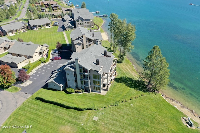 drone / aerial view with a water view and a residential view