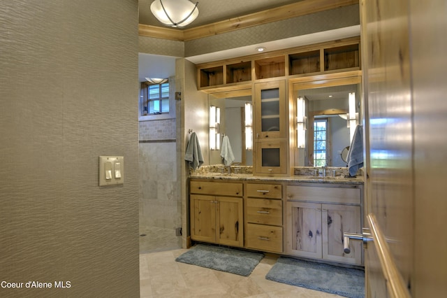 full bathroom featuring double vanity, a sink, and a walk in shower