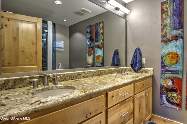 full bath with double vanity, visible vents, a sink, and recessed lighting