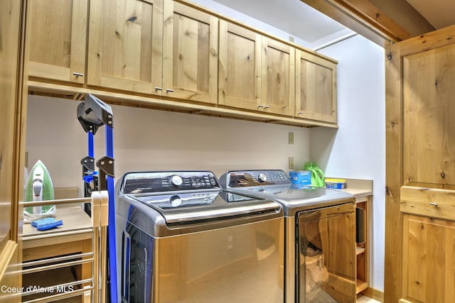 laundry room with cabinet space and washing machine and clothes dryer